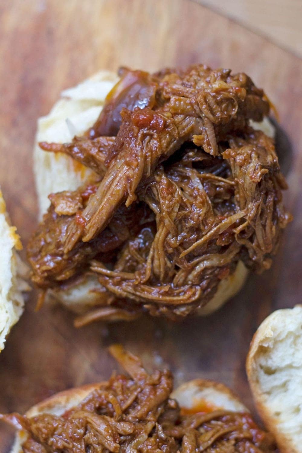 Beef brisket is slow cooked until meltingly tender for this spicy slow cooker pulled brisket. Serve in rolls or wraps for a delicious dinner!