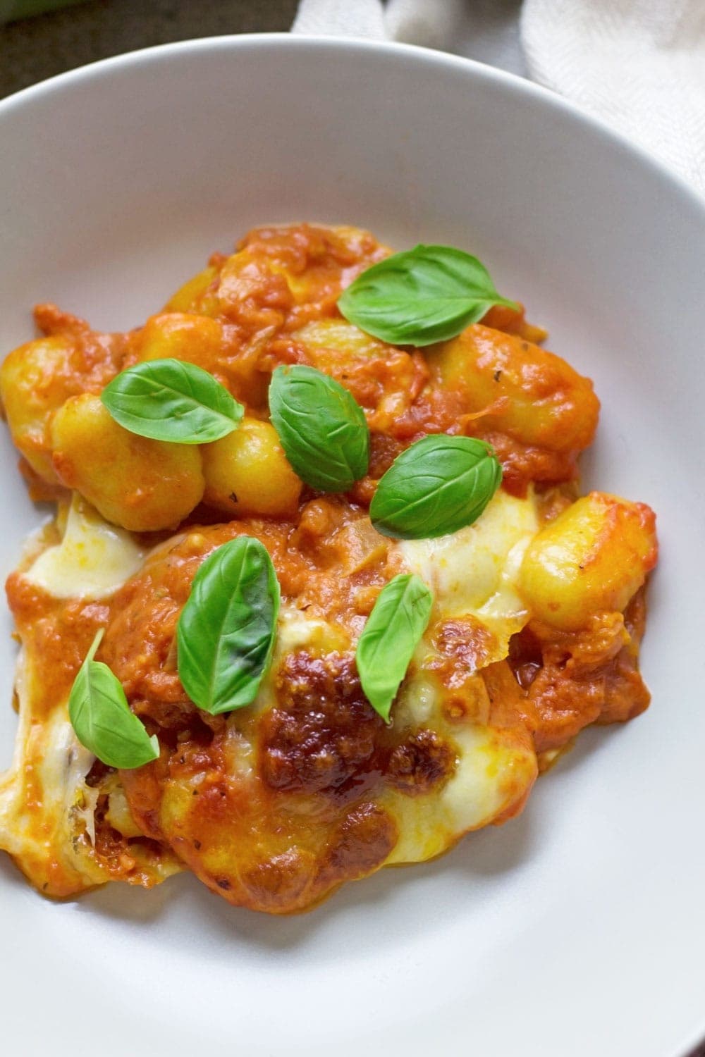 This cheese and tomato baked gnocchi is the perfect comfort dinner! Serve up a bowlful when you need a pick-me-up and you'll feel better in no time.