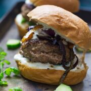 These Greek lamb burgers are served in a brioche bun. Topped with caramelised pepper and onion, refreshing cucumber and a drizzle of garlicky Greek yoghurt!