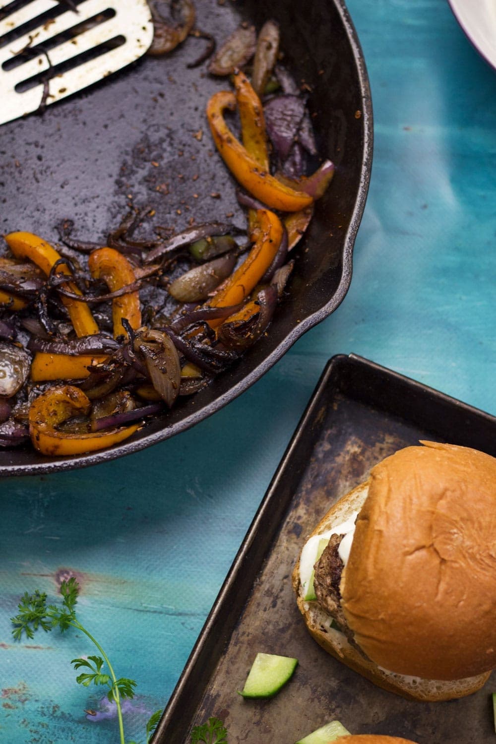 These Greek lamb burgers are served in a brioche bun. Topped with caramelised pepper and onion, refreshing cucumber and a drizzle of garlicky Greek yoghurt!