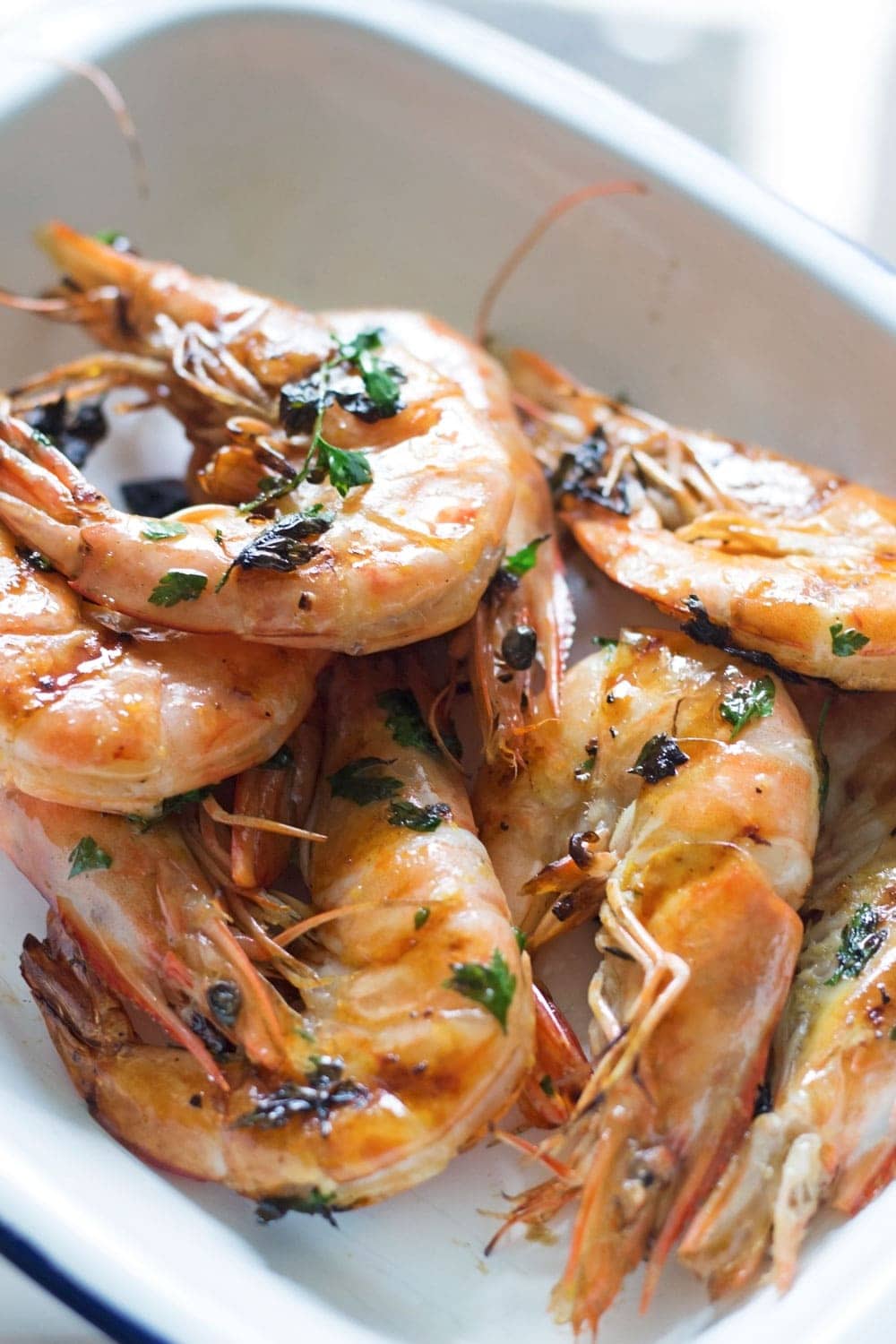 This chilli & garlic prawns recipe is the perfect thing to serve at a summer dinner party! It's quick, simple and is guaranteed to impress.