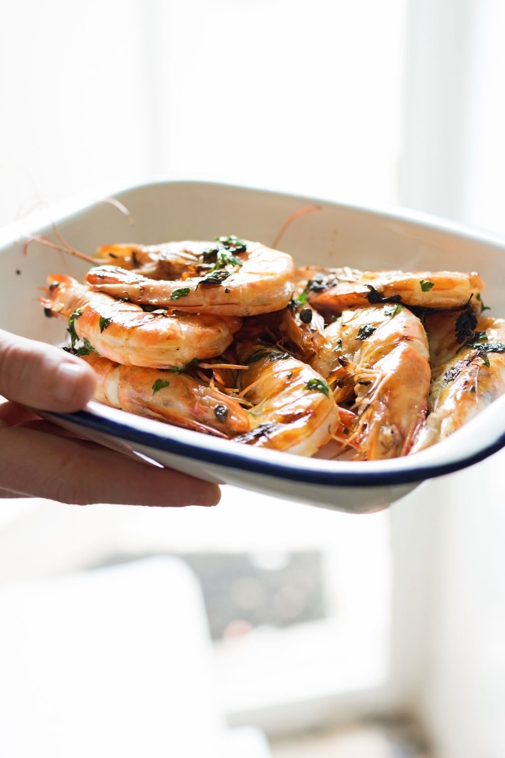 This chilli & garlic prawns recipe is the perfect thing to serve at a summer dinner party! It's quick, simple and is guaranteed to impress.