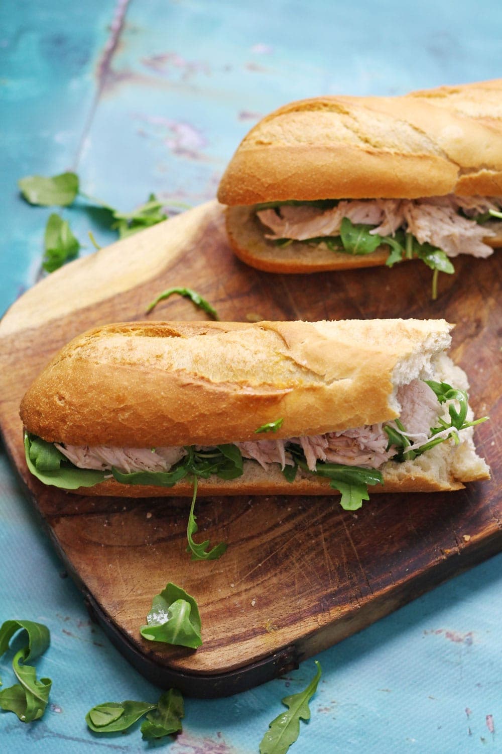 This lime & mint roast chicken sandwich recipe is a delicious weekend treat! Serve drizzled with garlic butter and topped with peppery rocket leaves.