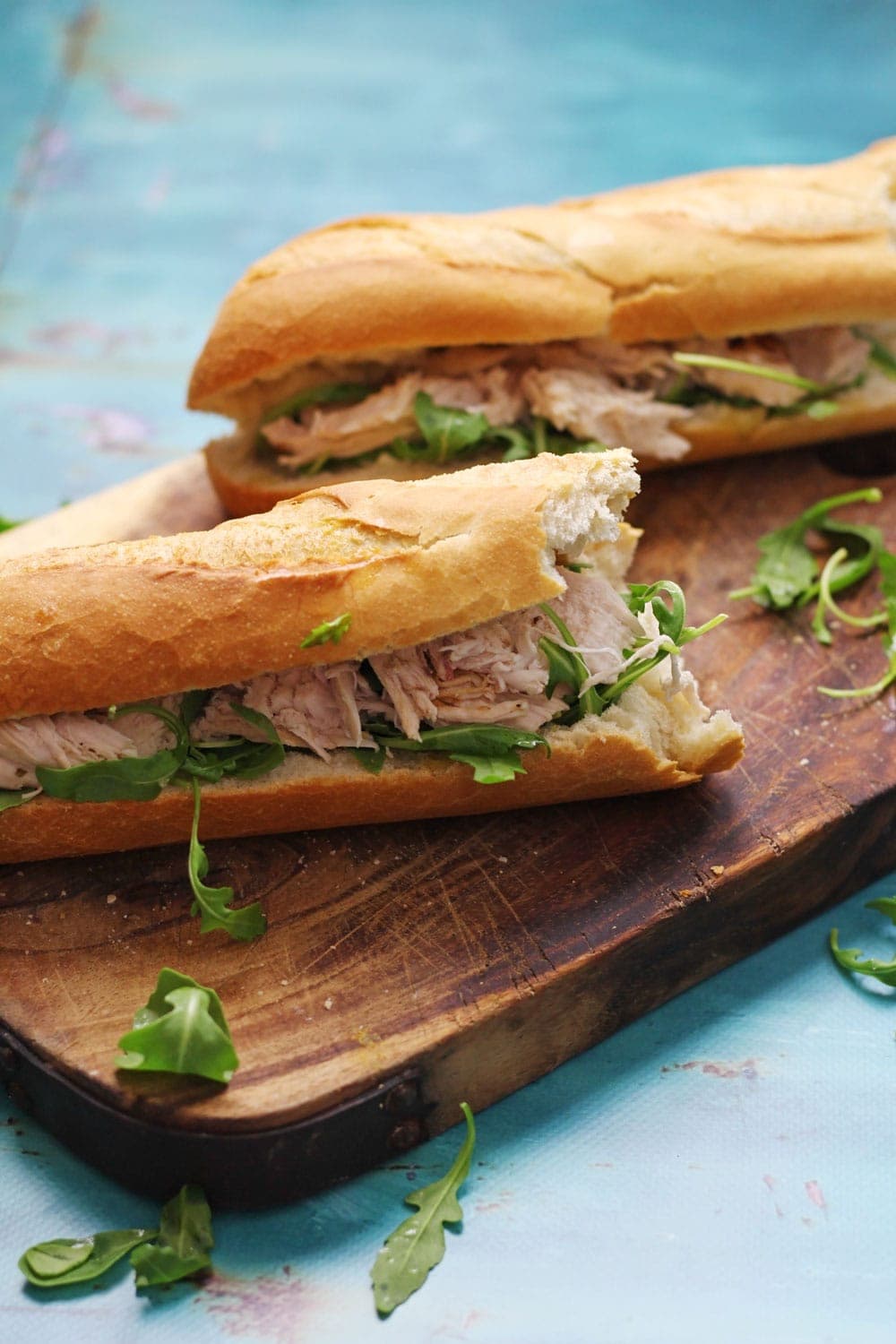 This lime & mint roast chicken sandwich recipe is a delicious weekend treat! Serve drizzled with garlic butter and topped with peppery rocket leaves.