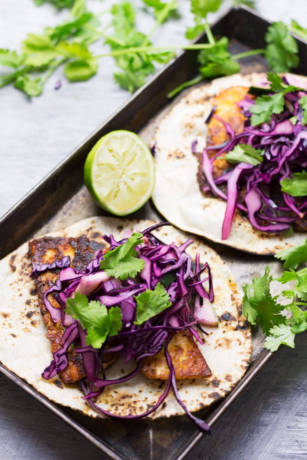 These halloumi tacos are beautifully spiced and topped with a fresh and healthy cabbage slaw. An ideal vegetarian Mexican dinner!