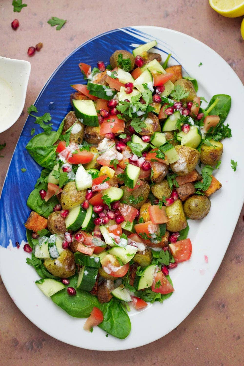 Overhead shot of potato salad on a blue and white platter 