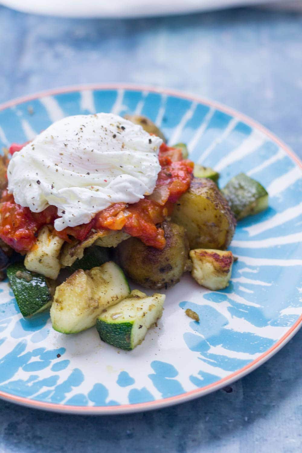 I love this potato, courgette & halloumi hash for breakfast, lunch or dinner! Topped with an easy tomato sauce & a poached egg it's a guaranteed winner.