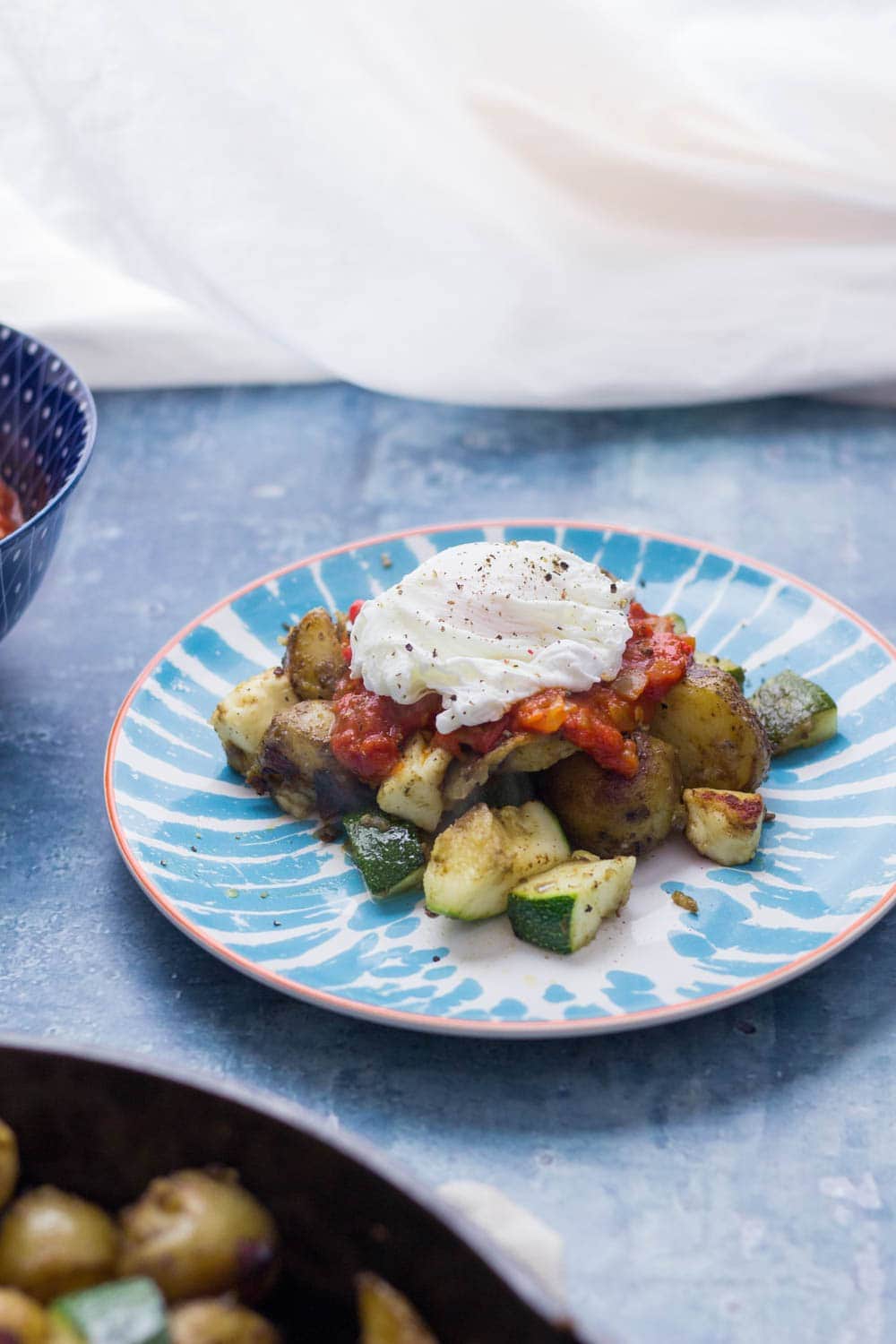 I love this potato, courgette & halloumi hash for breakfast, lunch or dinner! Topped with an easy tomato sauce & a poached egg it's a guaranteed winner.