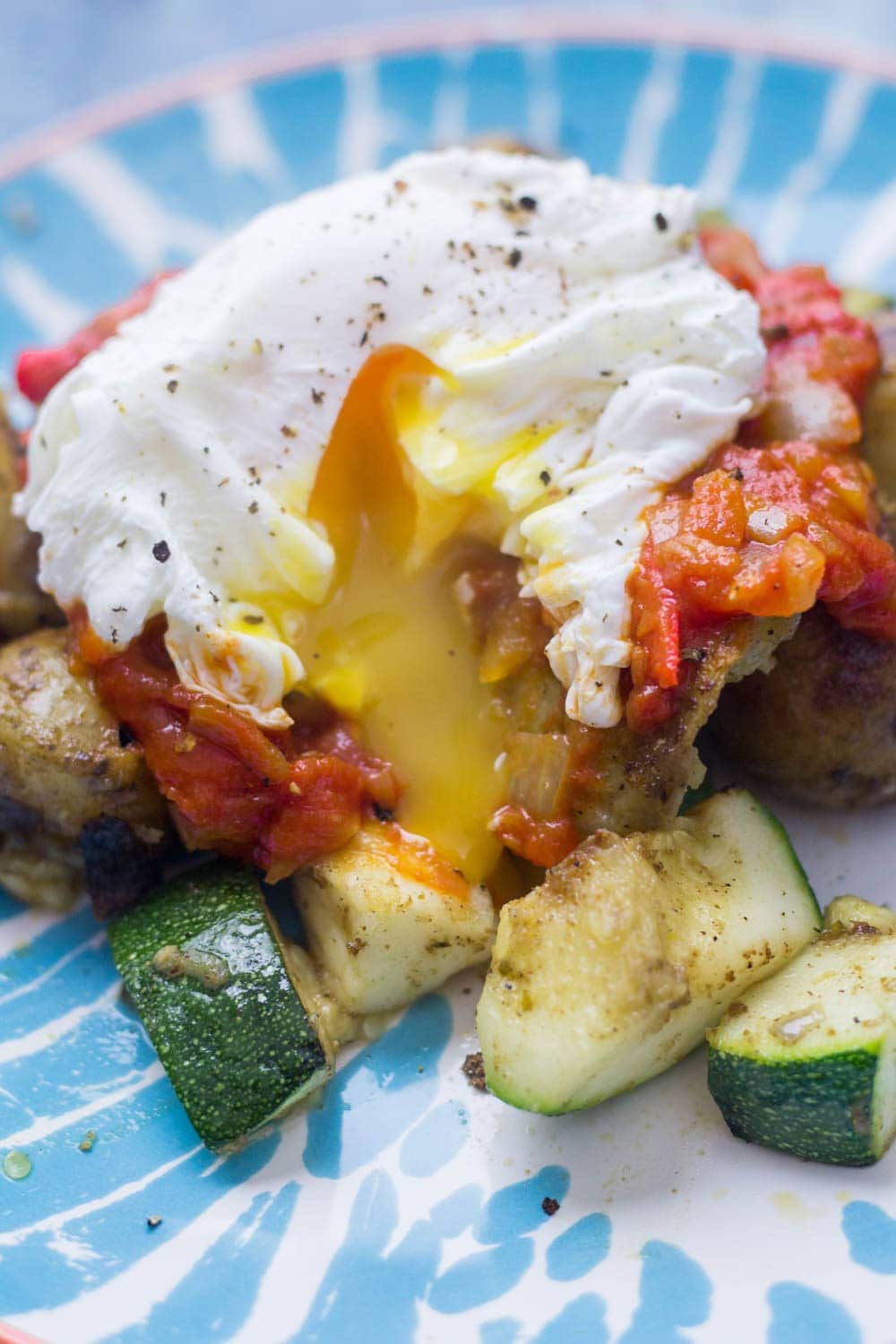 I love this potato, courgette & halloumi hash for breakfast, lunch or dinner! Topped with an easy tomato sauce & a poached egg it's a guaranteed winner.