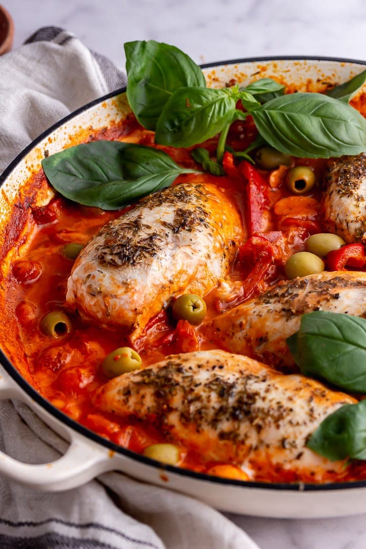 Side on shot of an Italian chicken skillet with basil 