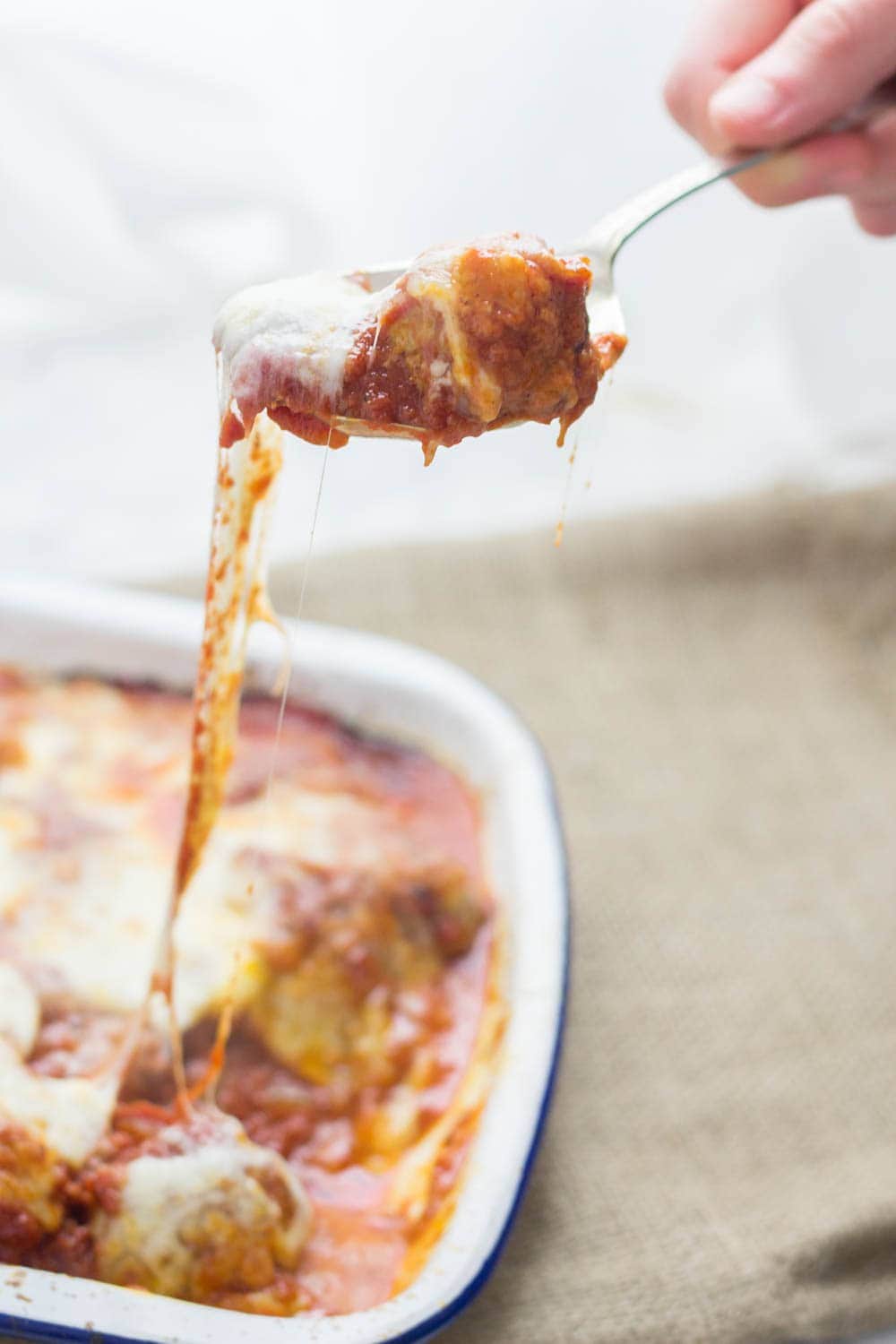 These cheesy baked meatball sandwiches are the perfect thing to feed a crowd! Serve for a party or just as a weeknight dinner the whole family will love.