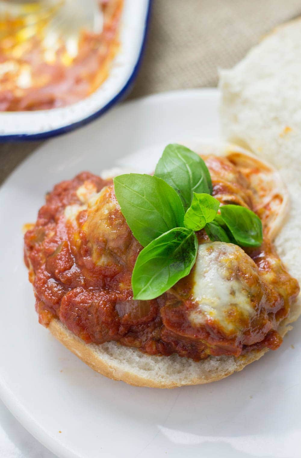 These cheesy baked meatball sandwiches are the perfect thing to feed a crowd! Serve for a party or just as a weeknight dinner the whole family will love.