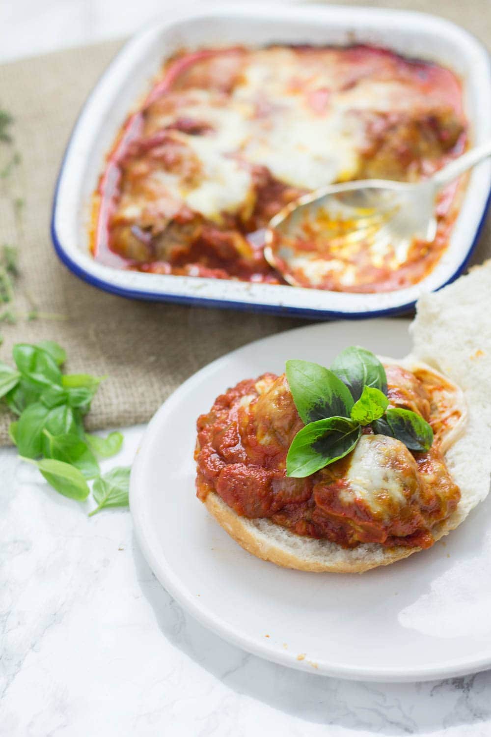 These cheesy baked meatball sandwiches are the perfect thing to feed a crowd! Serve for a party or just as a weeknight dinner the whole family will love.