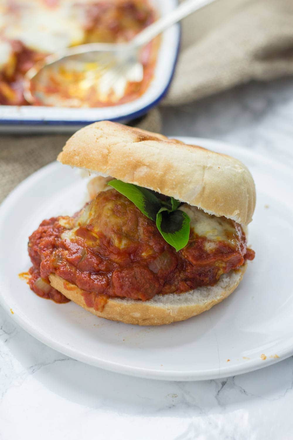 These cheesy baked meatball sandwiches are the perfect thing to feed a crowd! Serve for a party or just as a weeknight dinner the whole family will love.