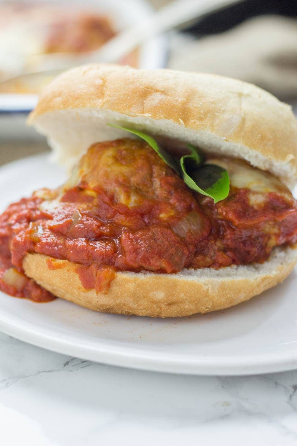 These cheesy baked meatball sandwiches are the perfect thing to feed a crowd! Serve for a party or just as a weeknight dinner the whole family will love.