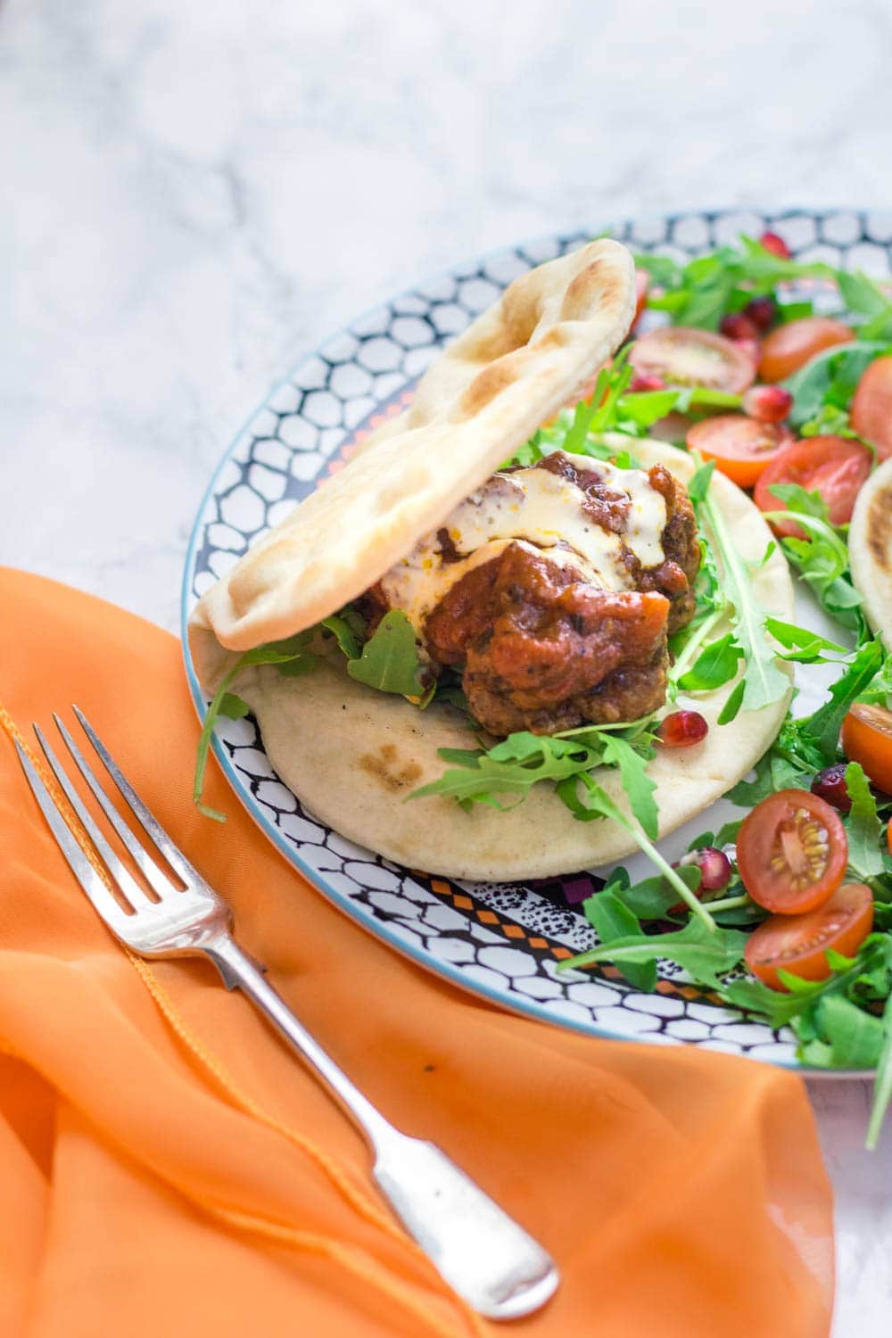 These Moroccan meatball flatbreads are surprisingly quick to make. The meatballs are simmered in a harissa tomato sauce and served with a drizzle of aioli.