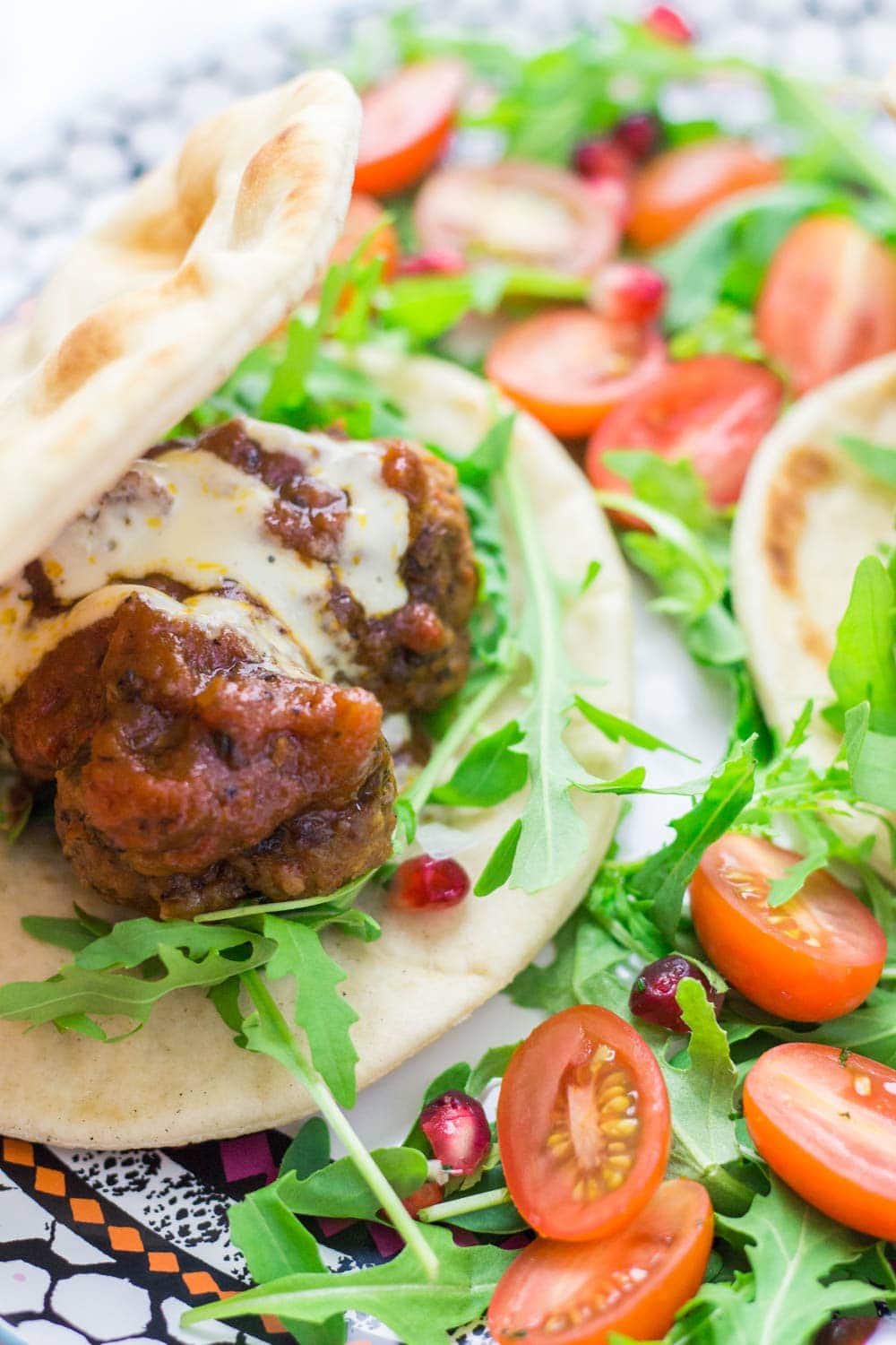 These Moroccan meatball flatbreads are surprisingly quick to make. The meatballs are simmered in a harissa tomato sauce and served with a drizzle of aioli.