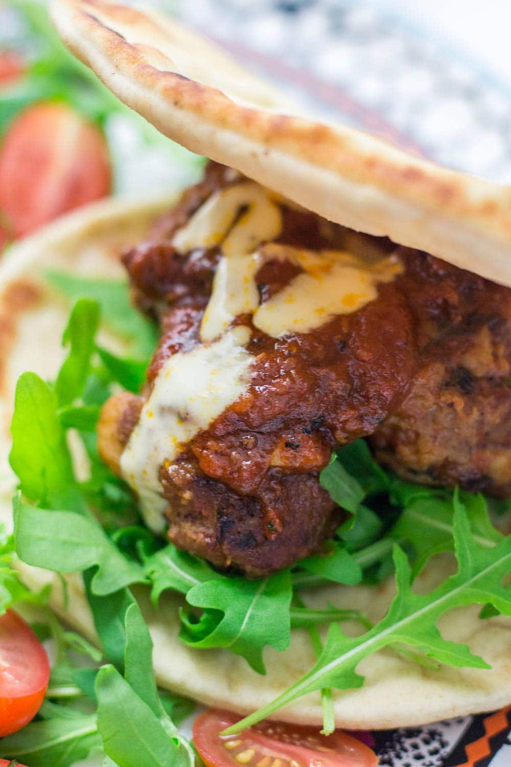 These Moroccan meatball flatbreads are surprisingly quick to make. The meatballs are simmered in a harissa tomato sauce and served with a drizzle of aioli.