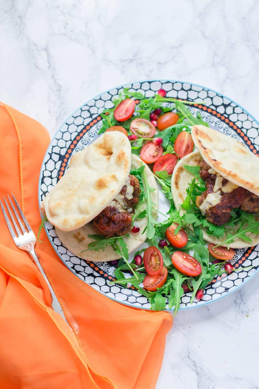 These Moroccan meatball flatbreads are surprisingly quick to make. The meatballs are simmered in a harissa tomato sauce and served with a drizzle of aioli.