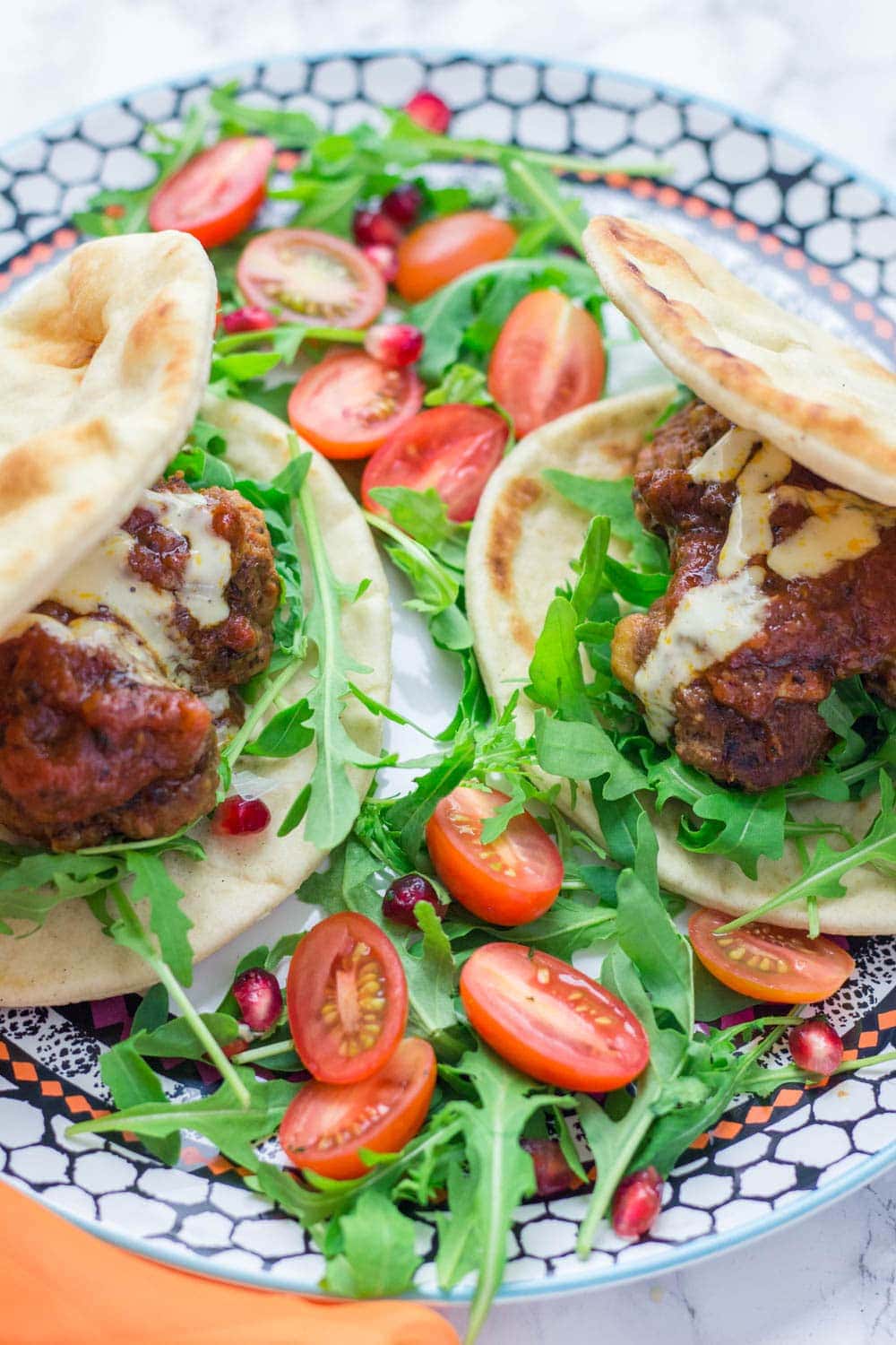 These Moroccan meatball flatbreads are surprisingly quick to make. The meatballs are simmered in a harissa tomato sauce and served with a drizzle of aioli.