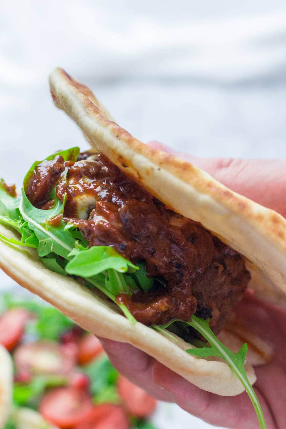 These Moroccan meatball flatbreads are surprisingly quick to make. The meatballs are simmered in a harissa tomato sauce and served with a drizzle of aioli.