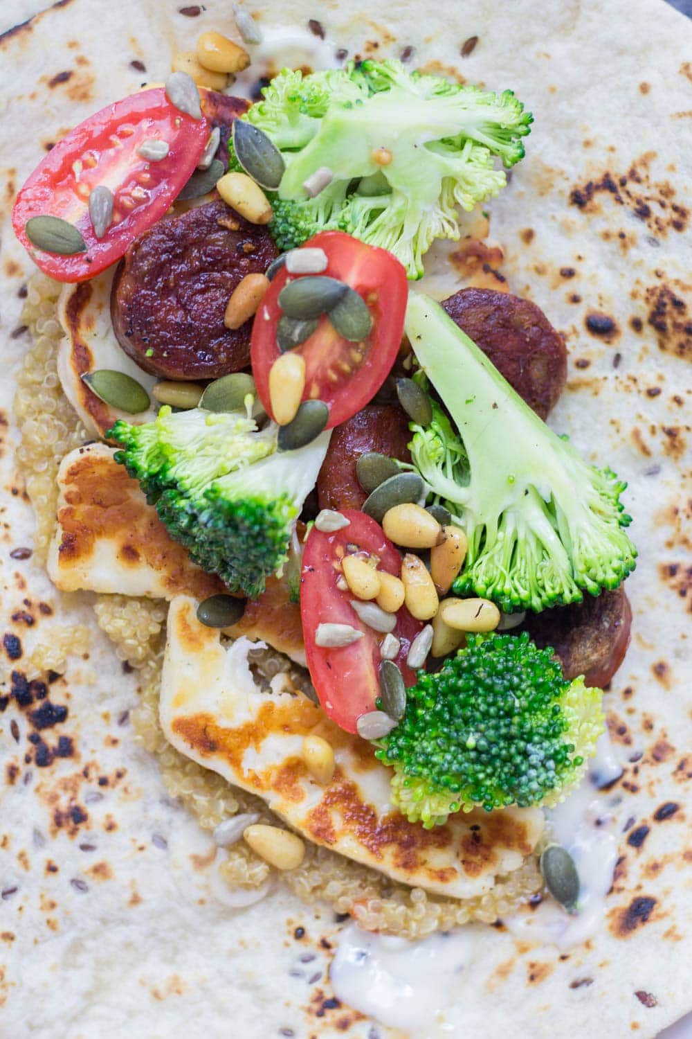 Halloumi & chorizo wraps are such a tasty lunch or dinner. The halloumi & chorizo are wrapped with a fresh broccoli slaw and a sprinkling of nuts and seeds.