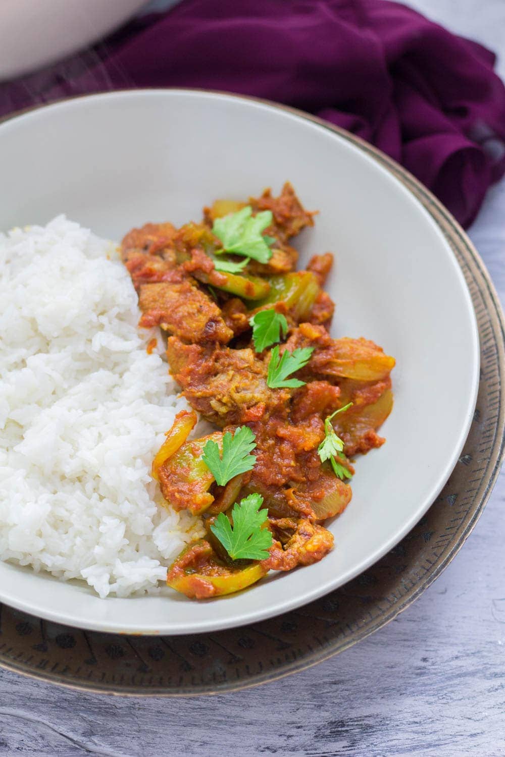 Bowl of leftover turkey curry on a blue background