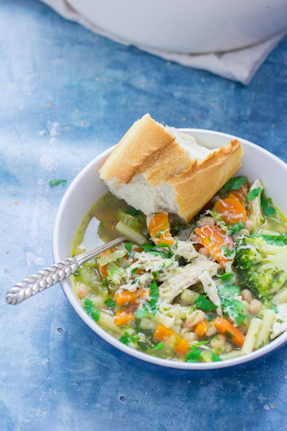 Bowl of chicken soup on a blue background