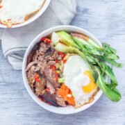 Japanese roast duck legs are shredded and served over sticky rice with pak choi, chilli and perfectly soft fried egg for a tasty dinner all in one bowl! #japanese #duck #roastduck #recipe #healthyrecipe