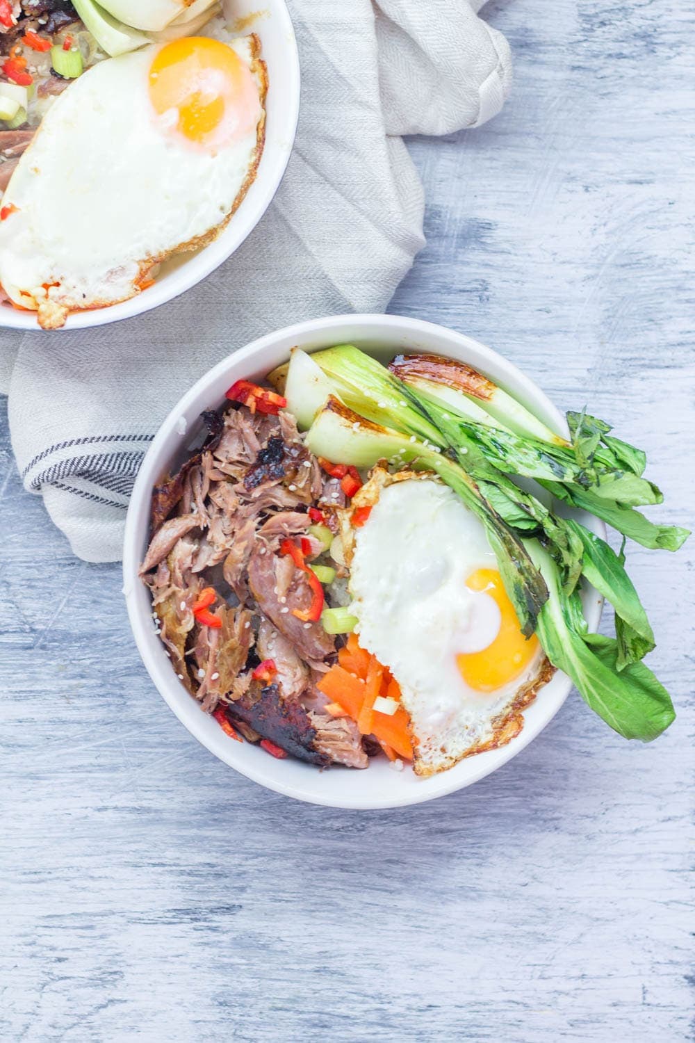 Japanese roast duck legs are shredded and served over sticky rice with pak choi, chilli and perfectly soft fried egg for a tasty dinner all in one bowl! #japanese #duck #roastduck #recipe #healthyrecipe