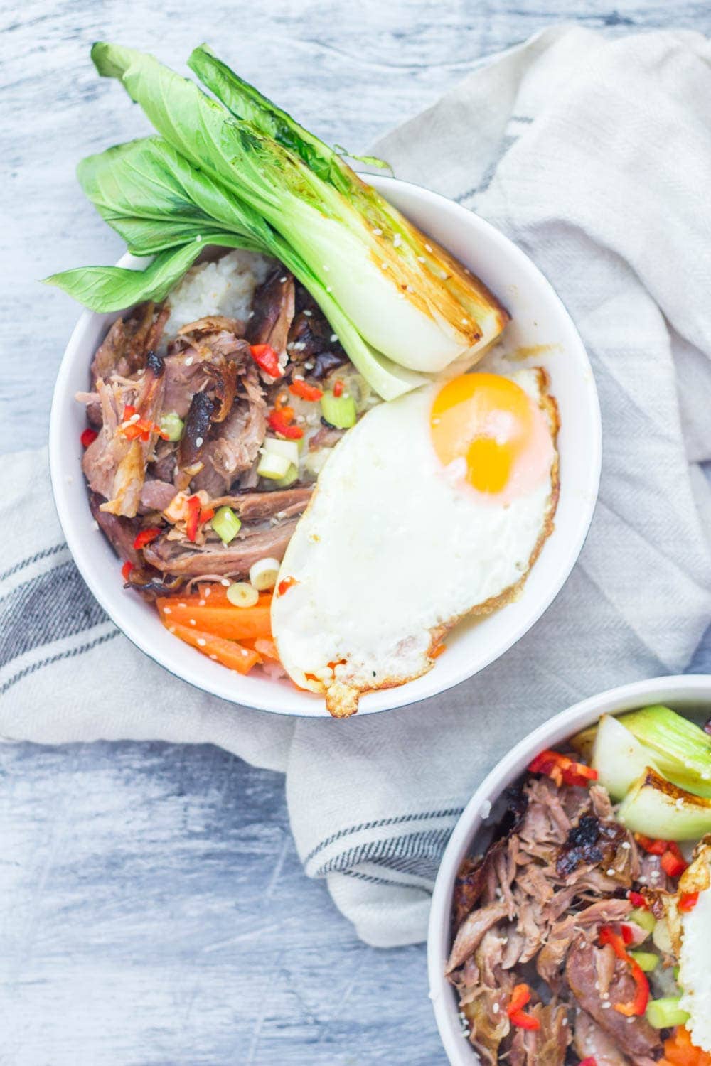 Japanese roast duck legs are shredded and served over sticky rice with pak choi, chilli and perfectly soft fried egg for a tasty dinner all in one bowl! #japanese #duck #roastduck #recipe #healthyrecipe