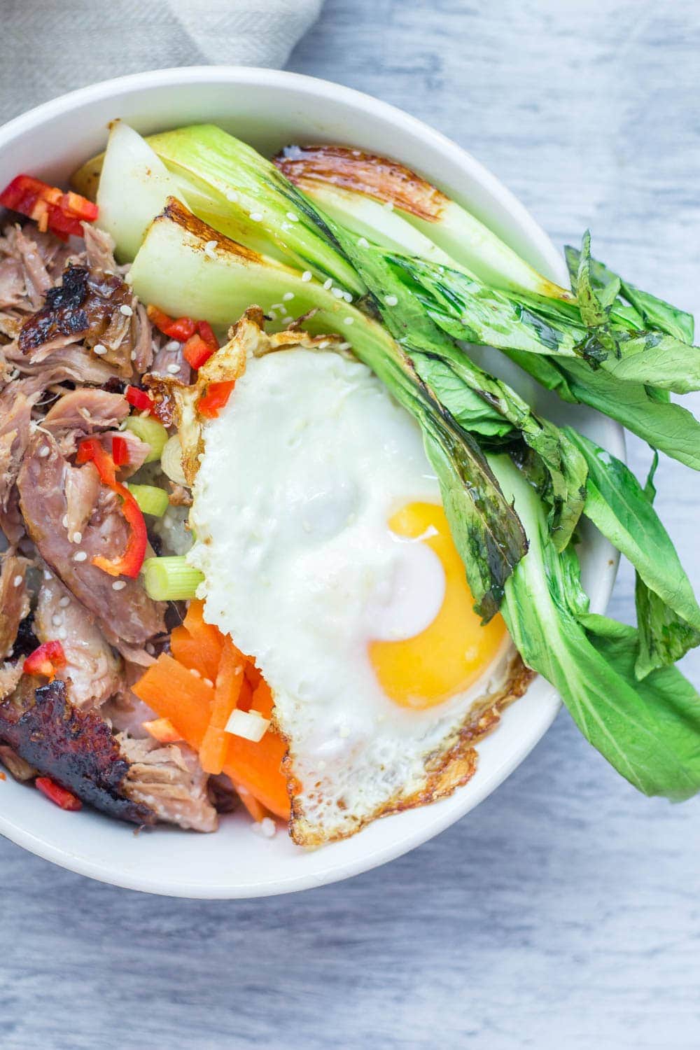 Japanese roast duck legs are shredded and served over sticky rice with pak choi, chilli and perfectly soft fried egg for a tasty dinner all in one bowl! #japanese #duck #roastduck #recipe #healthyrecipe