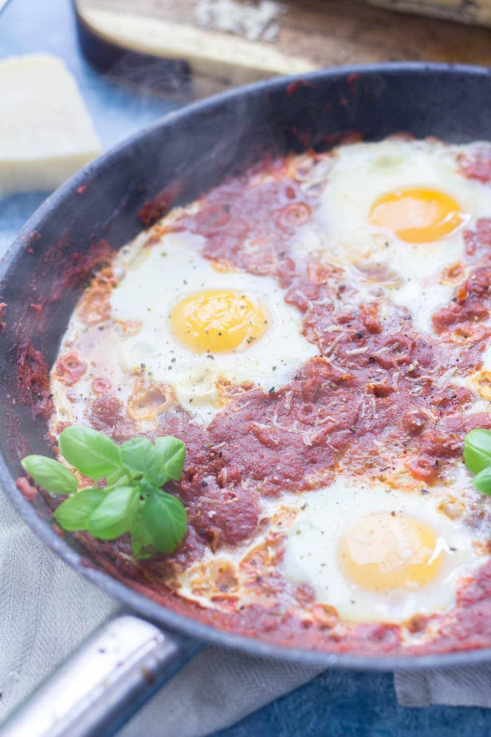 Serve up a hearty breakfast with this Italian shakshuka. Made with a delicious oregano tomato sauce and finished with a sprinkling of parmesan. #shakshuka #recipe #breakfast #brunch #italianfood