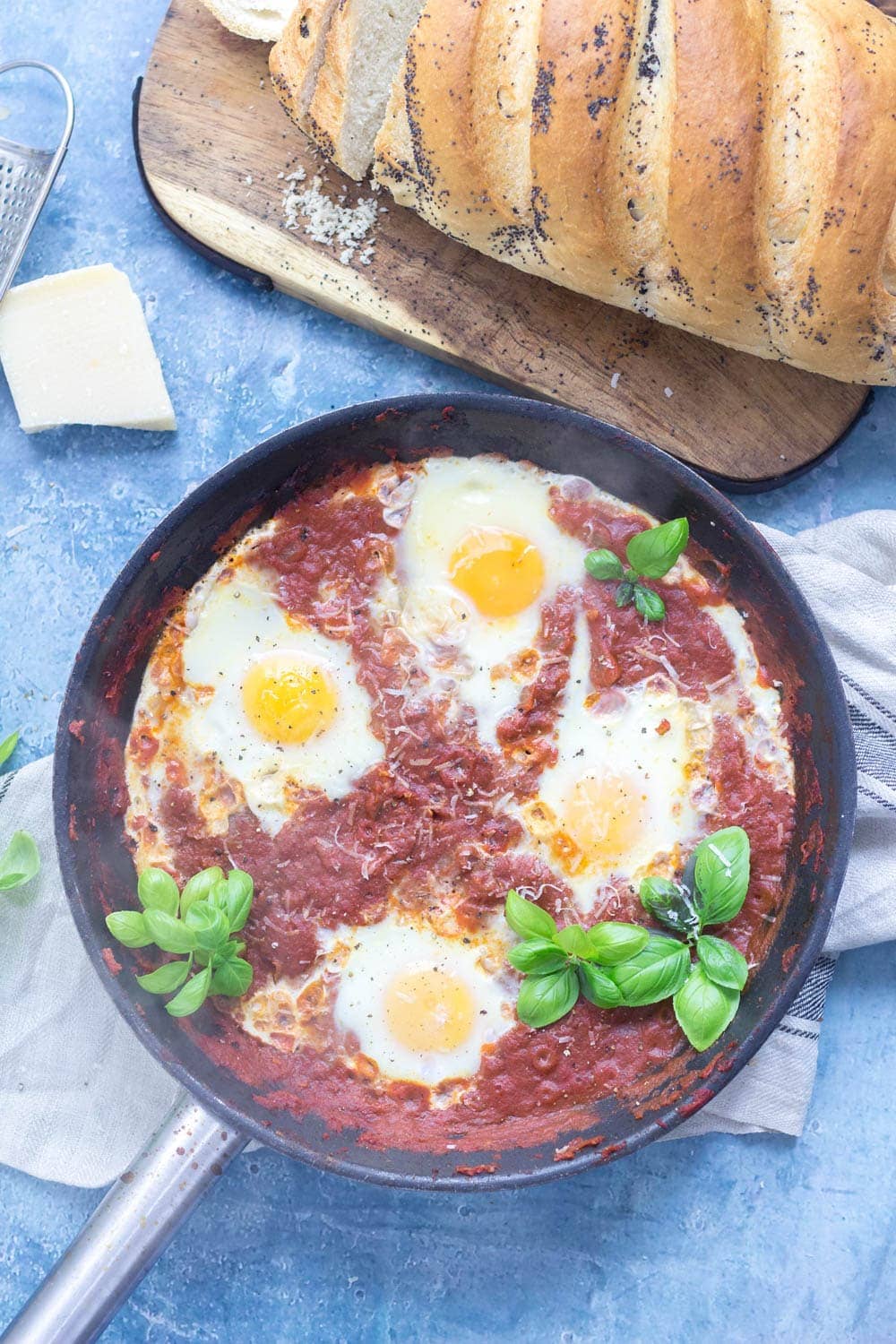 Serve up a hearty breakfast with this Italian shakshuka made with a delicious oregano tomato sauce and finished with a sprinkling of parmesan. #shakshuka #recipe #breakfast #brunch #italianfood