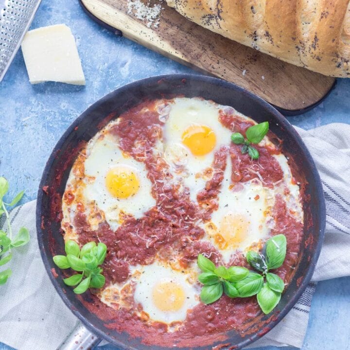 Serve up a hearty breakfast with this Italian twist on a shakshuka made with a delicious oregano tomato sauce and finished with a sprinkling of parmesan. #shakshuka #recipe #breakfast #brunch #italianfood