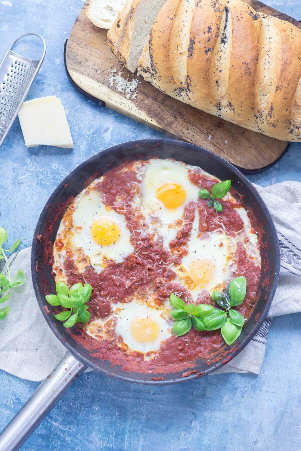 Serve up a hearty breakfast with this Italian shakshuka. Made with a delicious oregano tomato sauce and finished with a sprinkling of parmesan. #shakshuka #recipe #breakfast #brunch #italianfood