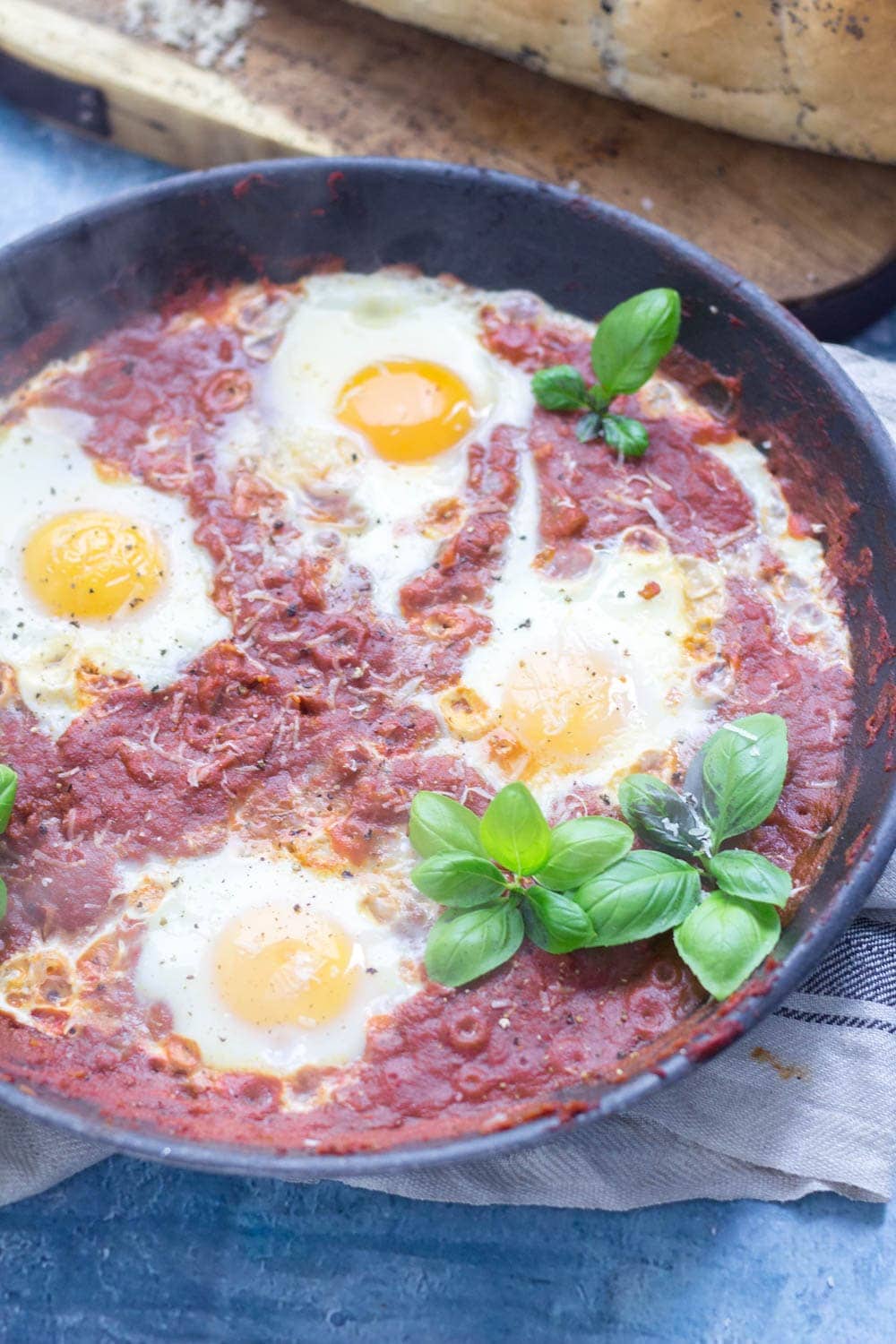 Serve up a hearty breakfast with this Italian shakshuka made with a delicious oregano tomato sauce and finished with a sprinkling of parmesan. #shakshuka #recipe #breakfast #brunch #italianfood