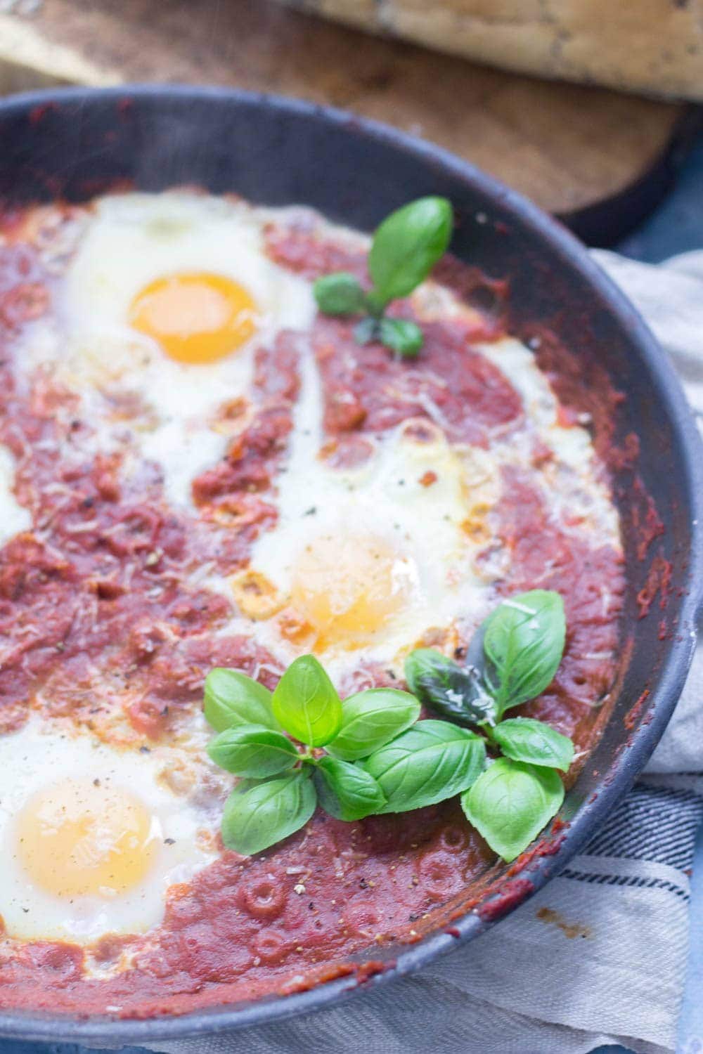 Serve up a hearty breakfast with this Italian shakshuka. Made with a delicious oregano tomato sauce and finished with a sprinkling of parmesan. #shakshuka #recipe #breakfast #brunch #italianfood