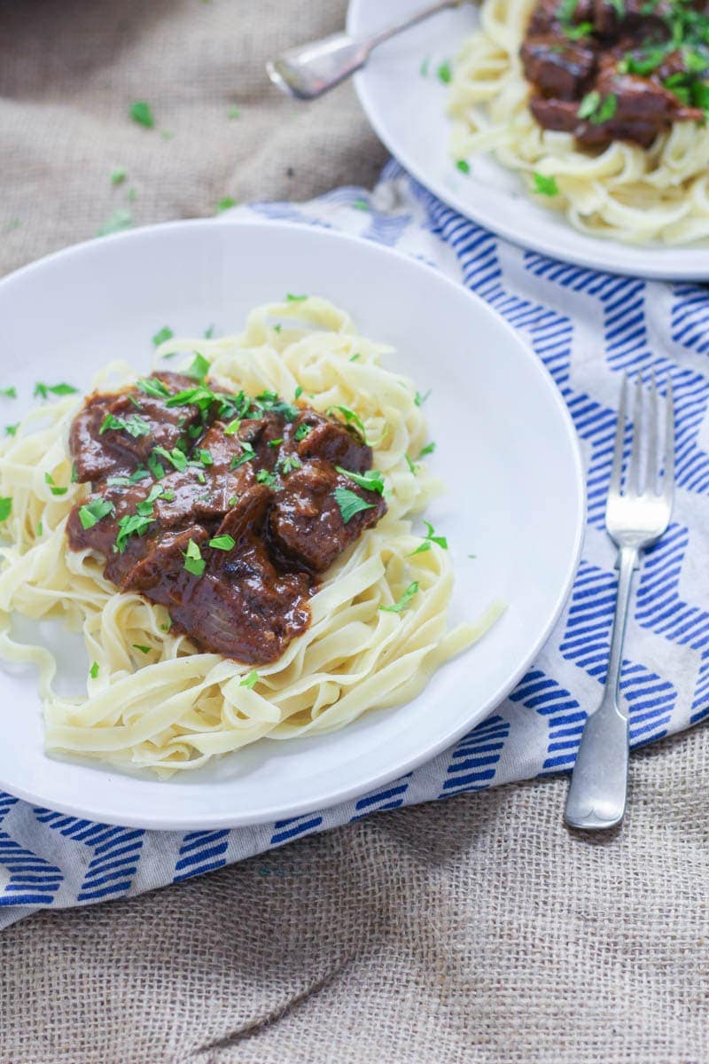 Easy Beef Stroganoff with Mushrooms. Make this easy beef stroganoff for a warming winter dinner. There's really nothing better than tender beef cooked with red wine and vegetables. #beefstroganoff #recipe #beef