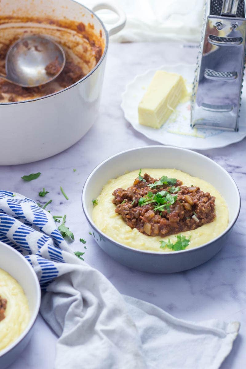 Five Ingredient Beef Ragu with Creamy Polenta. This beef ragu is the perfect quick, weeknight dinner. It takes only five ingredients to make and tastes amazing served over creamy, cheesy polenta. There's no better winter meal! #beefragu #polenta #recipe #dinner