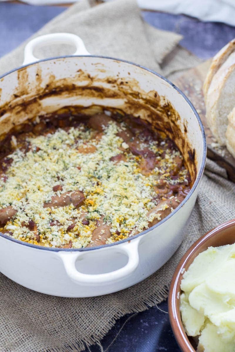 Sausage and Bean Casserole with Breadcrumb Topping. Sausage and bean casserole is perfect weekend comfort food but it works just as well served up at a dinner party! It can be made all in one pot so you can sit back and relax! #stew #sausage #beans #recipe