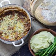 Sausage and Bean Stew with Breadcrumb Topping. Sausage and bean stew is perfect weekend comfort food but it works just as well served up at a dinner party! It can be made all in one pot so you can sit back and relax! #stew #sausage #beans #recipe