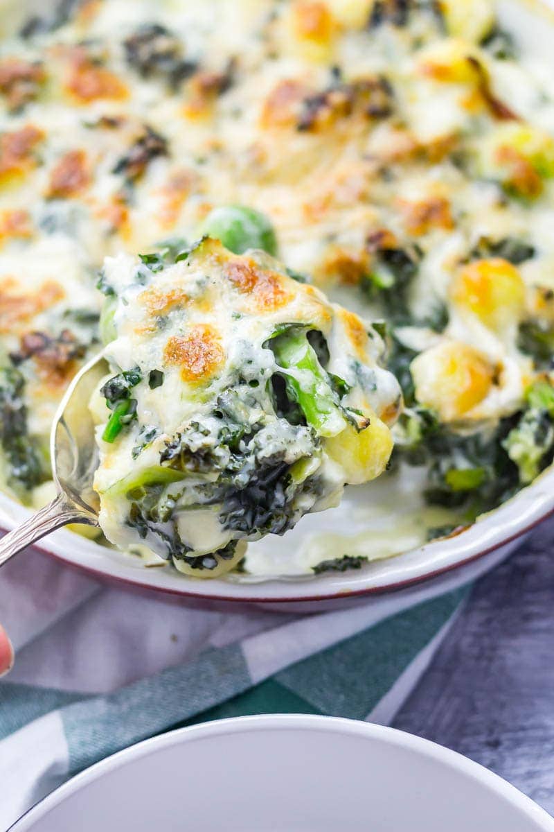 Cheesy Baked Gnocchi with Kale & Brussels Sprouts. There is nothing more comforting than this cheesy baked gnocchi. It's bulked out with kale and Brussels sprouts for a satisfying dinner which is still pretty healthy! #gnocchi #bakedgnocchi #kale #sprouts #comfortfood #recipe