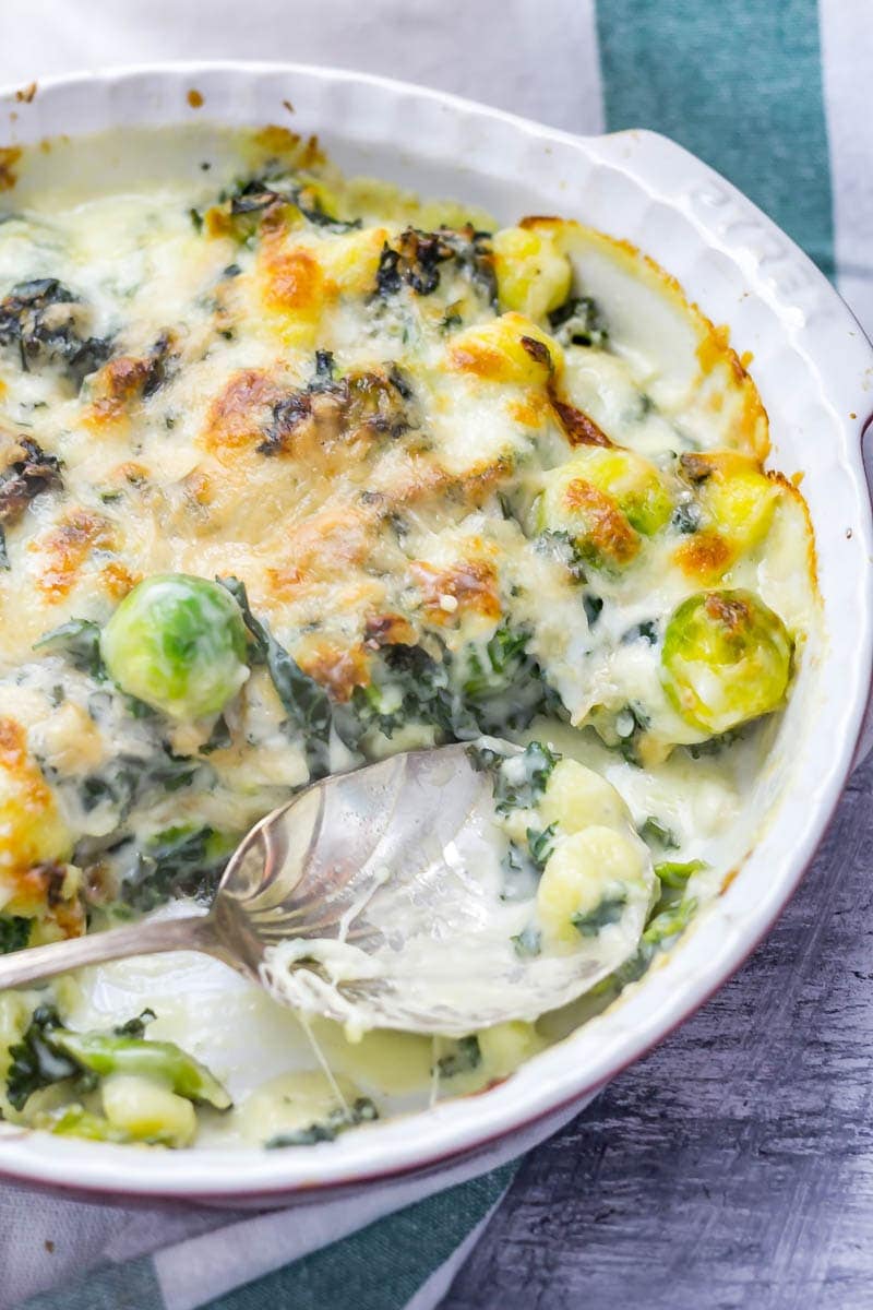 Cheesy Baked Gnocchi with Kale & Brussels Sprouts. There is nothing more comforting than this cheesy baked gnocchi. It's bulked out with kale and Brussels sprouts for a satisfying dinner which is still pretty healthy! #gnocchi #bakedgnocchi #kale #sprouts #comfortfood #recipe