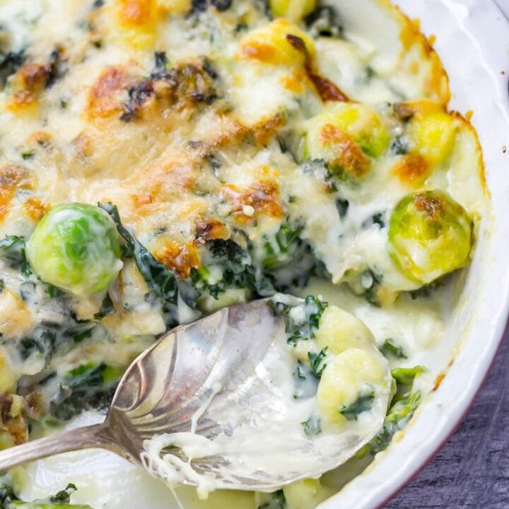Cheesy Baked Gnocchi with Kale & Brussels Sprouts. There is nothing more comforting than this cheesy baked gnocchi. It's bulked out with kale and Brussels sprouts for a satisfying dinner which is still pretty healthy! #gnocchi #bakedgnocchi #kale #sprouts #comfortfood #recipe