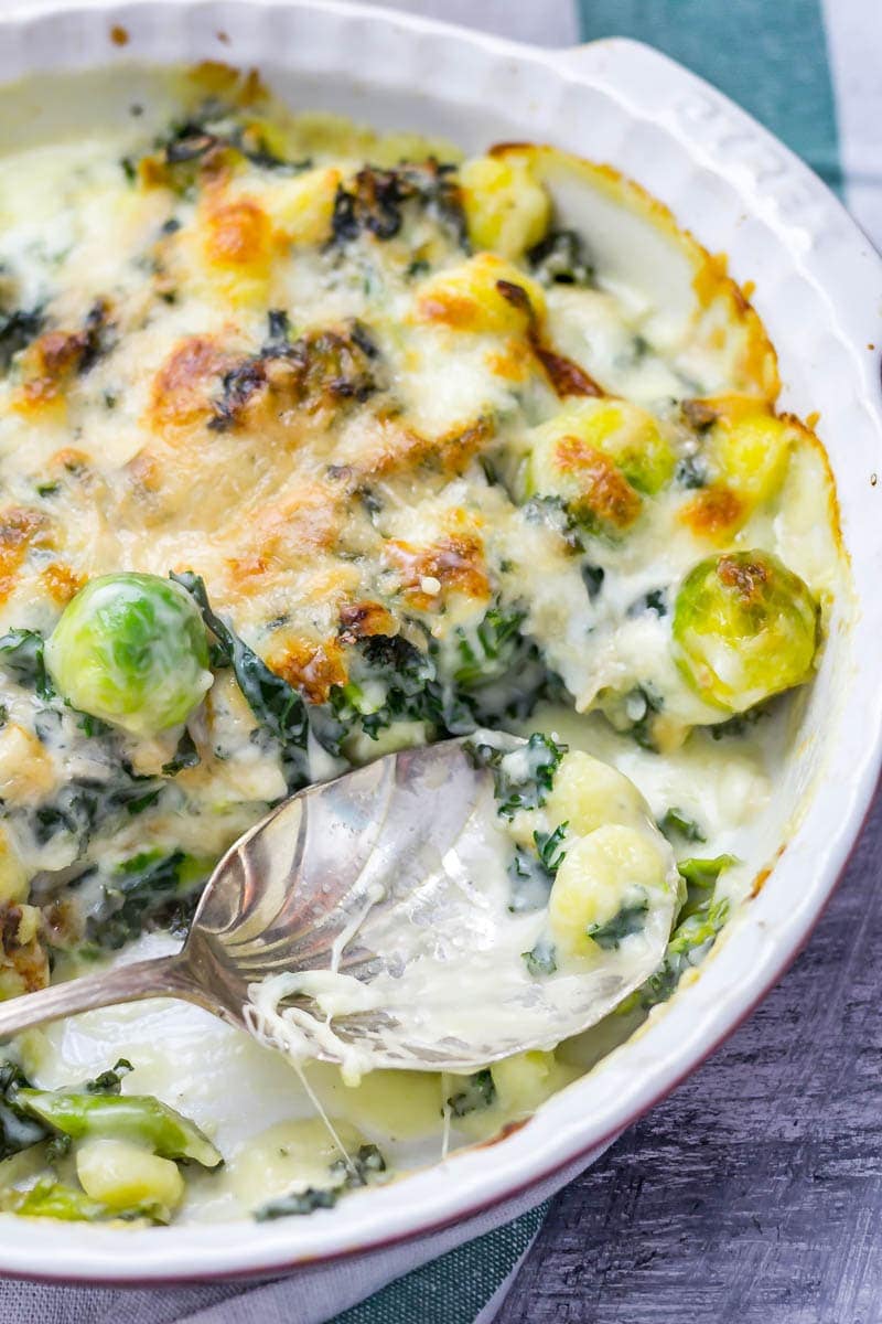 Cheesy Baked Gnocchi with Kale & Brussels Sprouts. There is nothing more comforting than this cheesy baked gnocchi. It's bulked out with kale and Brussels sprouts for a satisfying dinner which is still pretty healthy! #gnocchi #bakedgnocchi #kale #sprouts #comfortfood #recipe