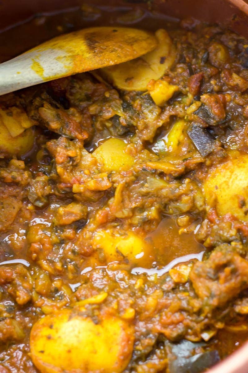 Close up of pressure cooker curry with wooden spoon