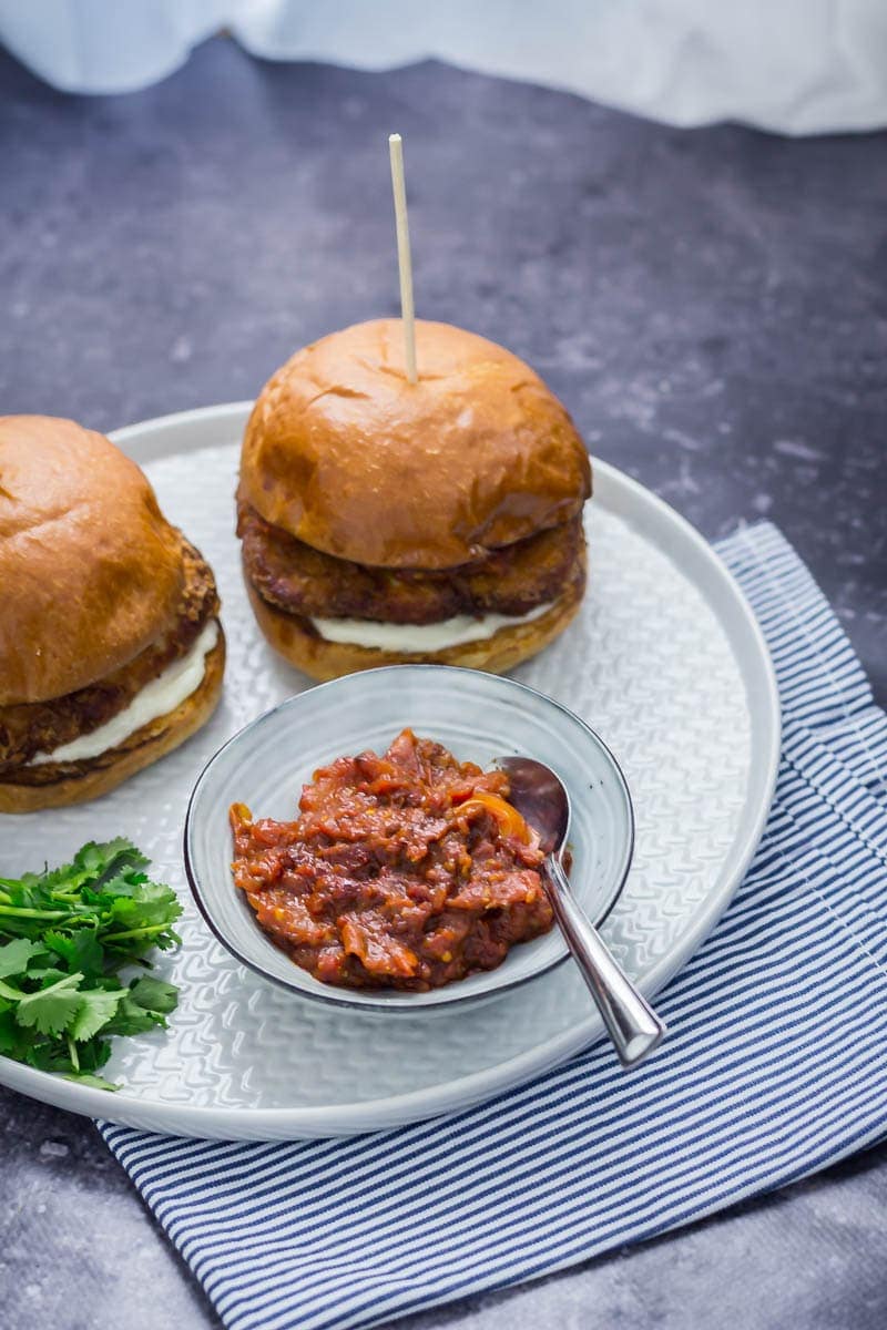 Panko halloumi sandwiches on a grey plate over a striped cloth