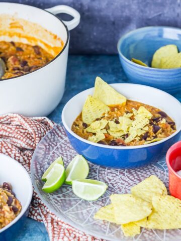 Mexican Rice & Vegetable Stew. Cheesy Mexican rice and vegetable tortilla stew is a tasty vegetarian weeknight dinner packed with beans, vegetables and spices! #mexican #rice #stew #vegetarian