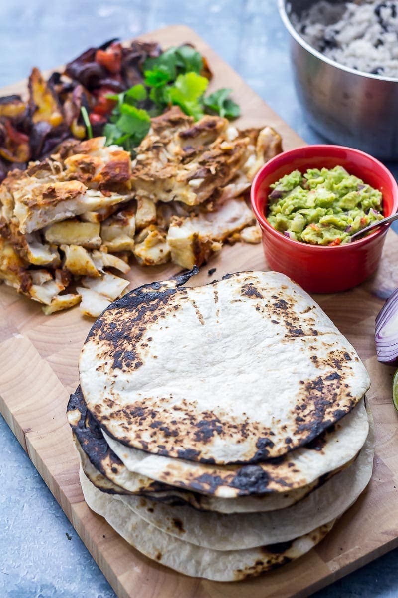 Fish tacos on a wooden board on a blue background